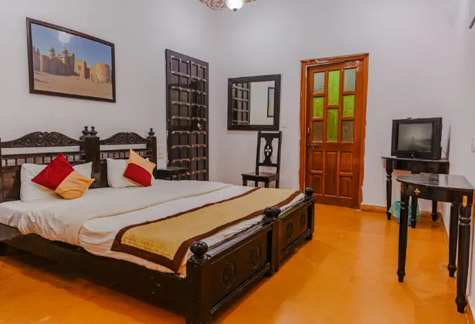 a bedroom with a bed and tv